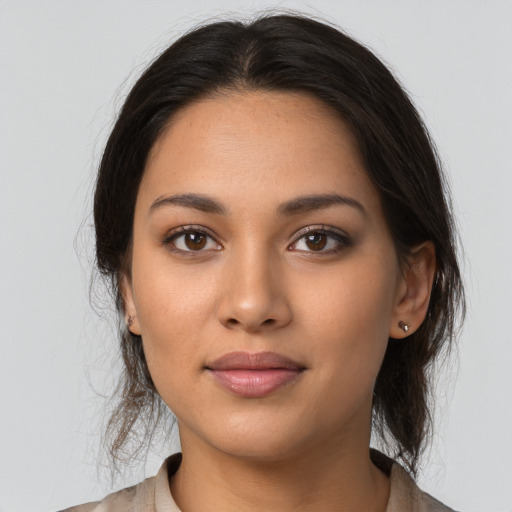 Joyful latino young-adult female with long  brown hair and brown eyes