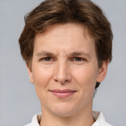 Joyful white adult male with short  brown hair and grey eyes