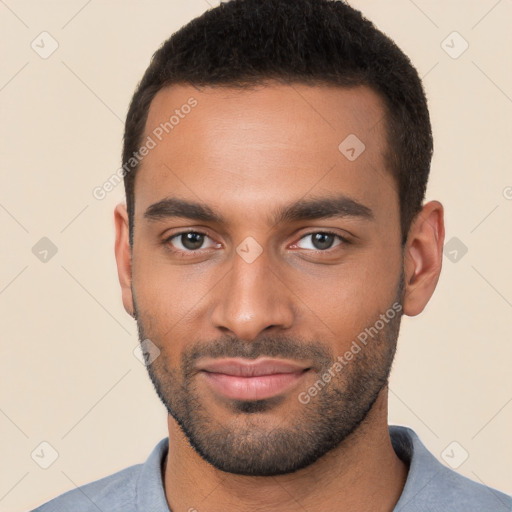 Joyful white young-adult male with short  black hair and brown eyes