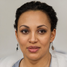 Joyful latino adult female with short  brown hair and brown eyes