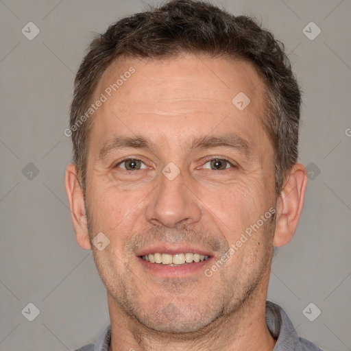 Joyful white adult male with short  brown hair and brown eyes