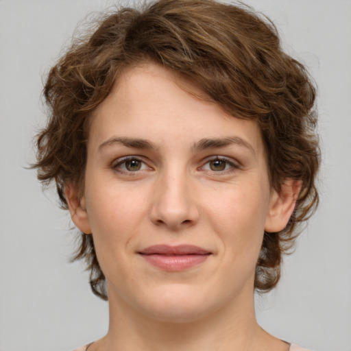 Joyful white young-adult female with medium  brown hair and green eyes