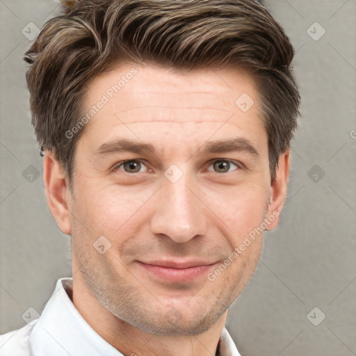 Joyful white young-adult male with short  brown hair and brown eyes