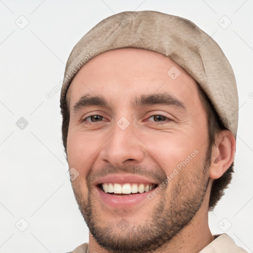 Joyful white young-adult male with short  black hair and brown eyes