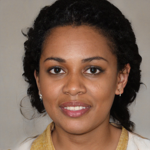 Joyful black young-adult female with medium  black hair and brown eyes