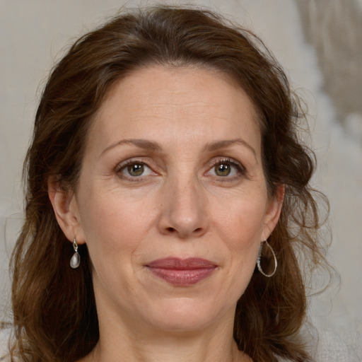 Joyful white adult female with medium  brown hair and grey eyes