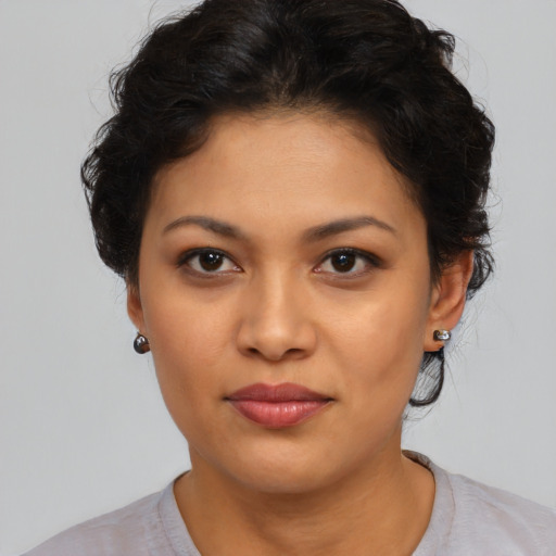 Joyful latino young-adult female with short  brown hair and brown eyes