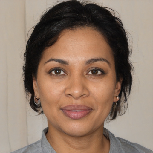 Joyful black adult female with medium  brown hair and brown eyes