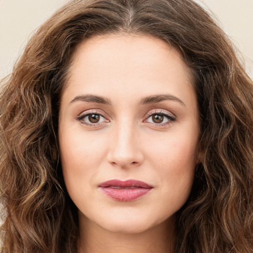 Joyful white young-adult female with long  brown hair and green eyes