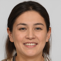 Joyful white adult female with medium  brown hair and brown eyes