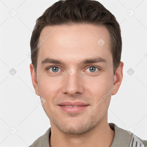 Joyful white young-adult male with short  brown hair and grey eyes