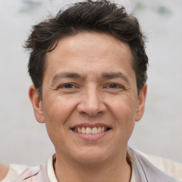 Joyful white adult male with short  brown hair and brown eyes