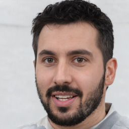 Joyful white young-adult male with short  black hair and brown eyes