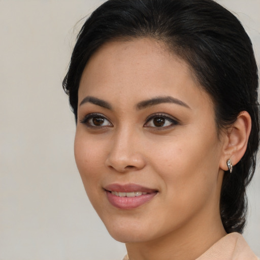 Joyful latino young-adult female with medium  brown hair and brown eyes