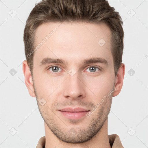 Joyful white young-adult male with short  brown hair and grey eyes