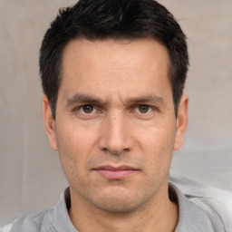 Neutral white adult male with short  black hair and brown eyes