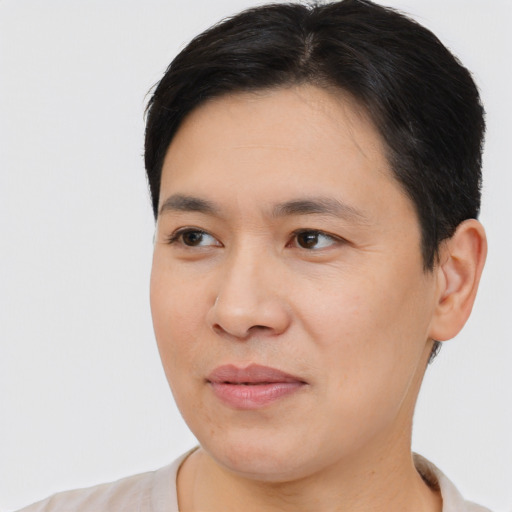 Joyful asian young-adult female with short  brown hair and brown eyes