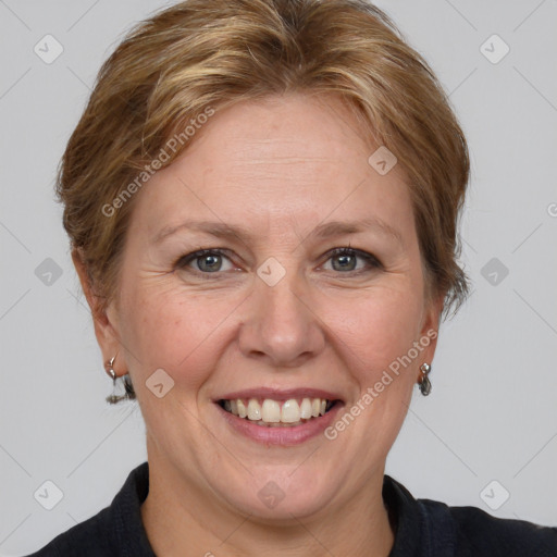 Joyful white adult female with medium  brown hair and grey eyes