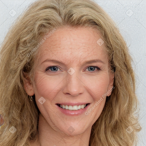 Joyful white adult female with medium  brown hair and blue eyes