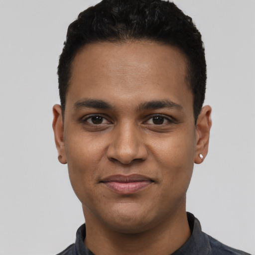 Joyful latino young-adult male with short  black hair and brown eyes