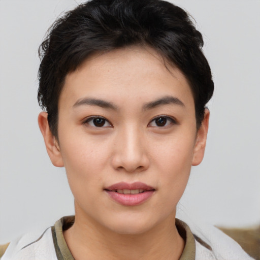 Joyful asian young-adult female with short  brown hair and brown eyes