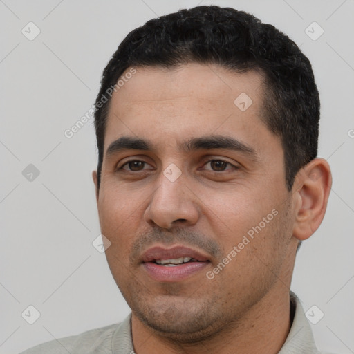 Joyful white young-adult male with short  black hair and brown eyes