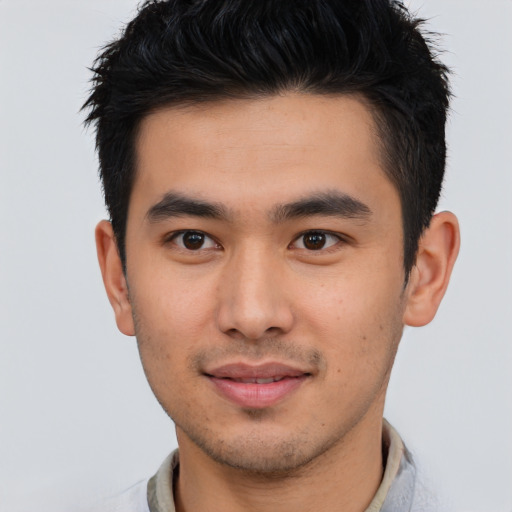 Joyful asian young-adult male with short  brown hair and brown eyes