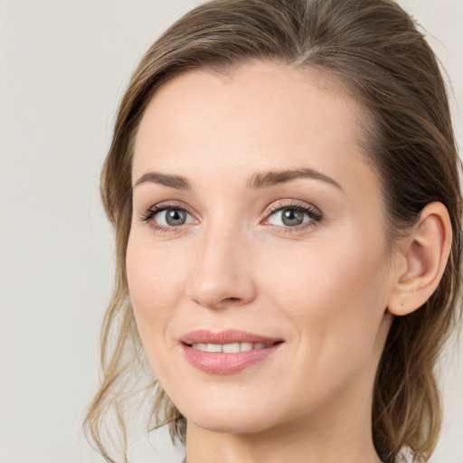 Joyful white young-adult female with medium  brown hair and grey eyes