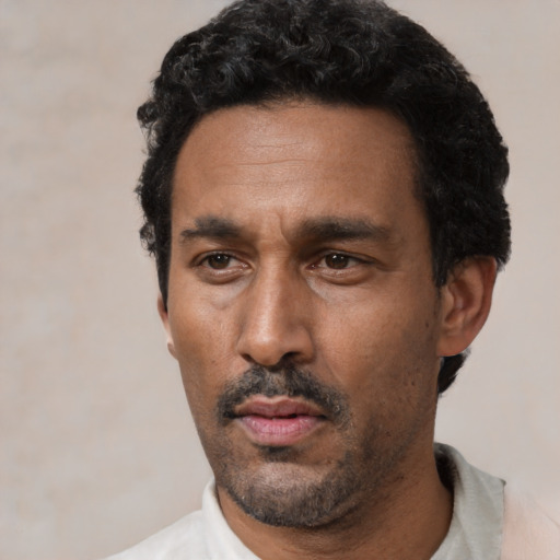 Neutral latino adult male with short  black hair and brown eyes