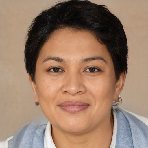 Joyful latino young-adult female with short  brown hair and brown eyes
