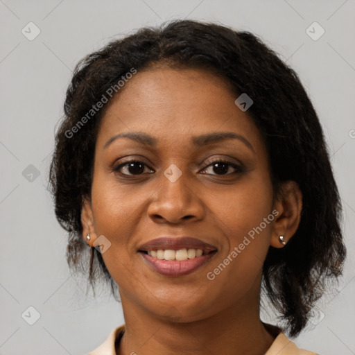 Joyful black adult female with medium  brown hair and brown eyes