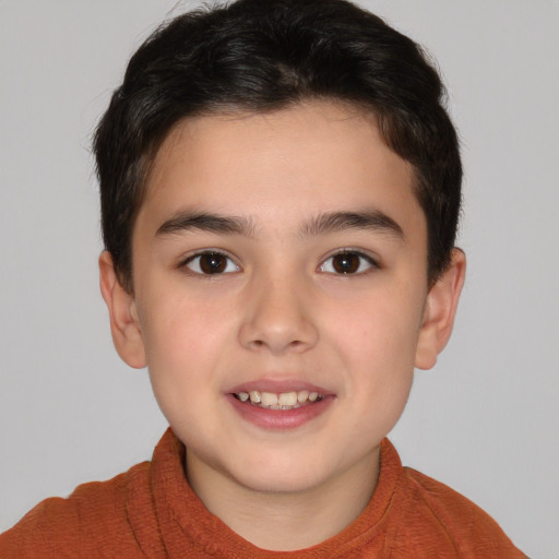 Joyful white child male with short  brown hair and brown eyes