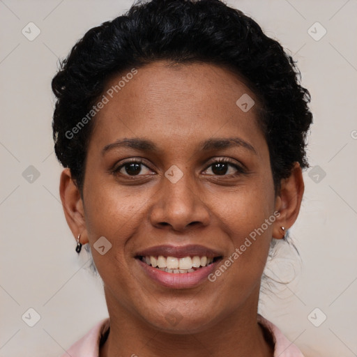 Joyful black young-adult female with short  black hair and brown eyes