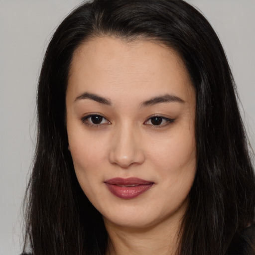 Joyful asian young-adult female with long  brown hair and brown eyes