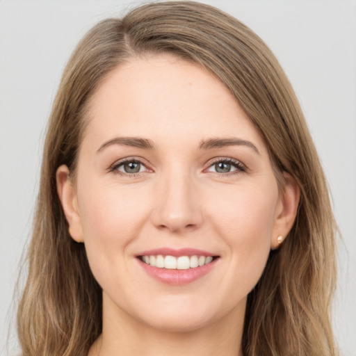 Joyful white young-adult female with long  brown hair and grey eyes