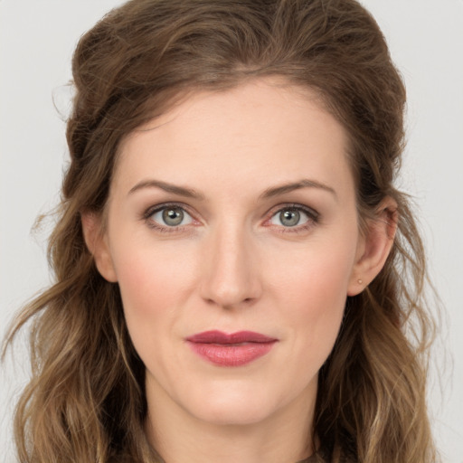 Joyful white young-adult female with long  brown hair and grey eyes