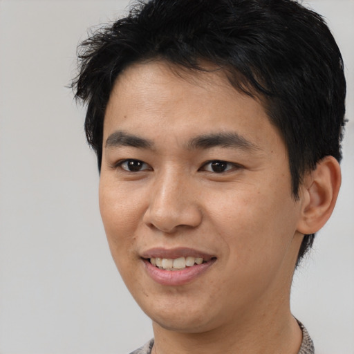 Joyful asian young-adult male with short  black hair and brown eyes