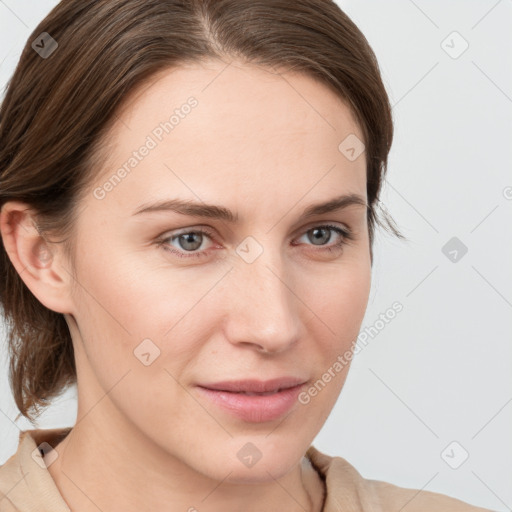 Joyful white young-adult female with medium  brown hair and blue eyes