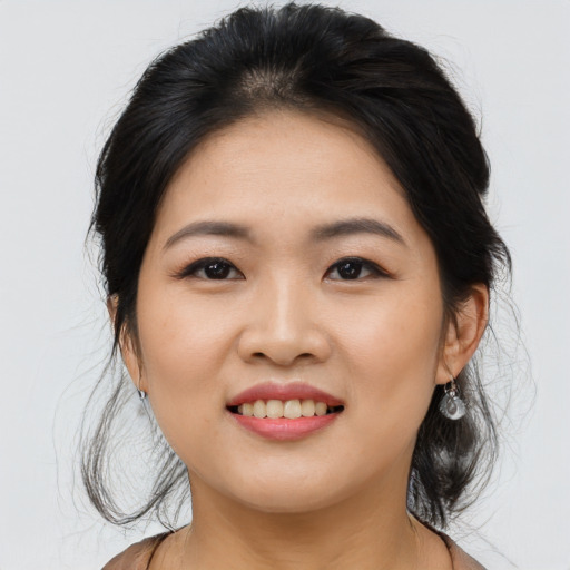 Joyful asian young-adult female with medium  black hair and brown eyes