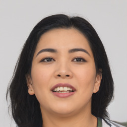 Joyful asian young-adult female with long  brown hair and brown eyes