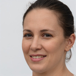 Joyful white adult female with medium  brown hair and brown eyes