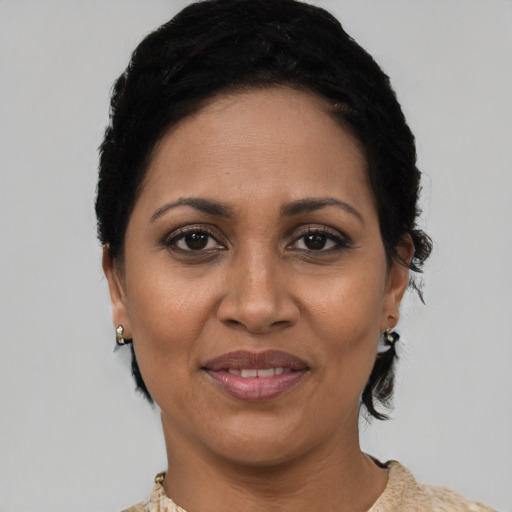 Joyful latino adult female with short  black hair and brown eyes