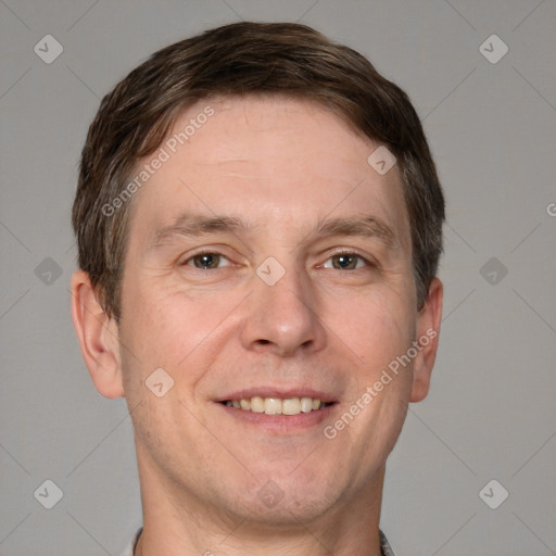 Joyful white adult male with short  brown hair and grey eyes