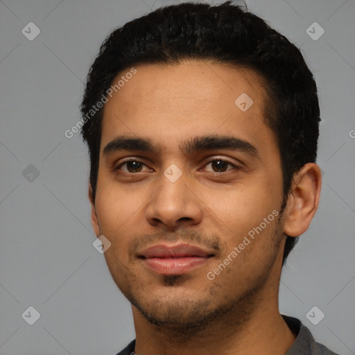 Joyful latino young-adult male with short  black hair and brown eyes