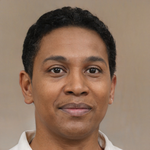 Joyful latino young-adult male with short  brown hair and brown eyes