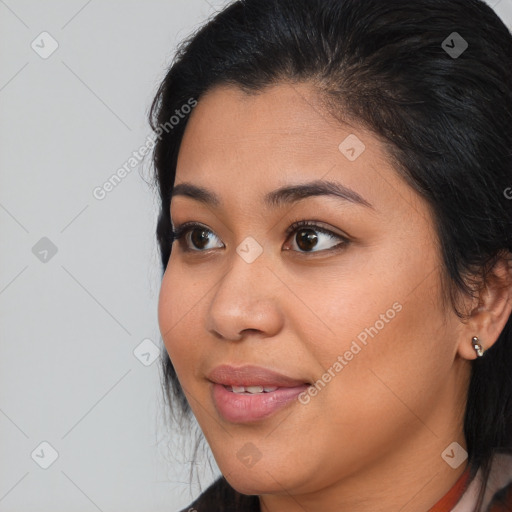 Joyful latino young-adult female with medium  brown hair and brown eyes