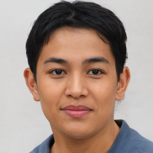 Joyful asian young-adult male with short  brown hair and brown eyes