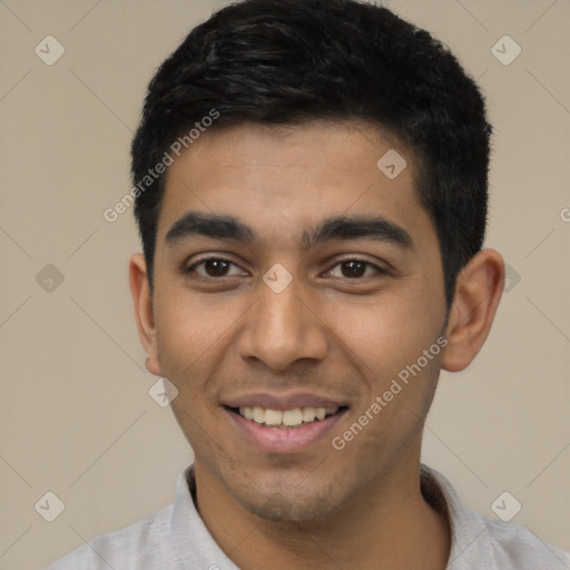 Joyful latino young-adult male with short  black hair and brown eyes