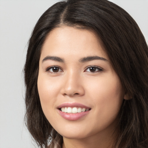 Joyful white young-adult female with long  brown hair and brown eyes