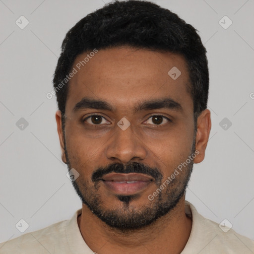 Joyful black young-adult male with short  black hair and brown eyes